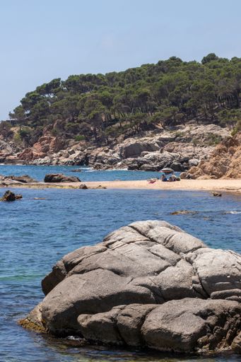 A  vertical shot of a nudist beach on a sunny day in Palamos, Costa Brava, Spain