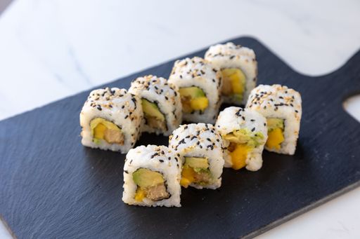 A closeup shot of delicious gourmet inside-out sushi rolls on a wooden board