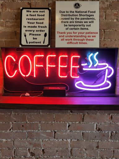This vibrant neon sign reads 'Coffee'