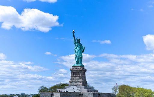 A beautiful shot of the Statue of Liberty against a cloudy blue sky in New York, USA
