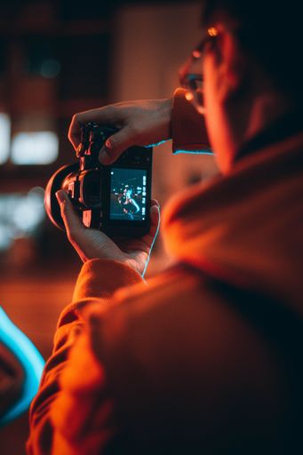 A man taking photos using a camera, vertical shot
