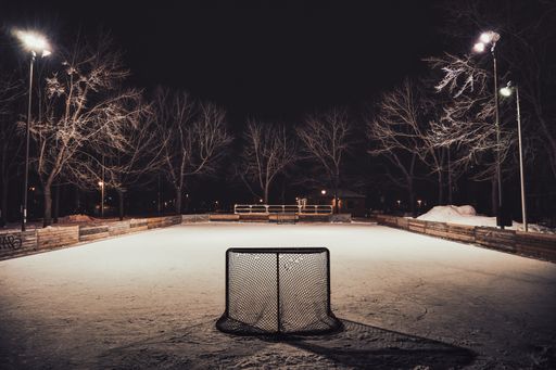 An illuminated hockey field at night