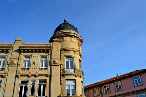 A low-angle shot of the blue sky over the old building in Porto, Portugal