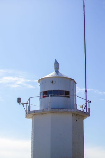 A vertical shot of a lighthouse on a sunny day