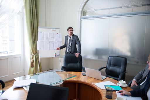 Successful business professionals presenting new project while working together with colleagues in the modern office