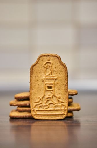 Polish Krakuski ginger biscuits with lighthouse on a wooden table