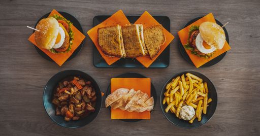 A top view of a tasty burgers sandwiches, fries with souse and meal with meat