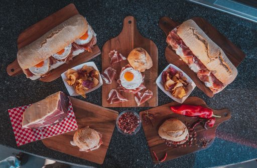 A top view of a bacon sandwich and omelet on the boards