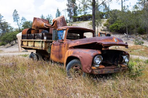 An old ruined truck abandoned in a field