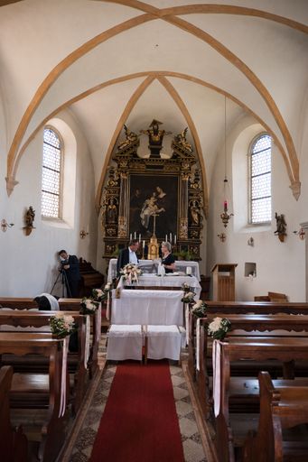 A vertical shot of inner part of a sanctuary in Bolzano, Italy prepared for a wedding