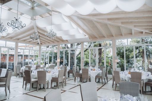 A decorated wedding hall with tables during celebration