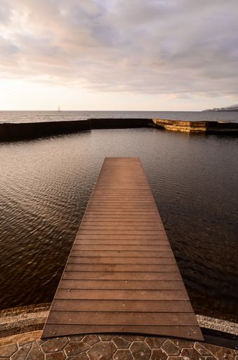 A wooden pier over calm coast in Tenerife, Canary Islands, Spain