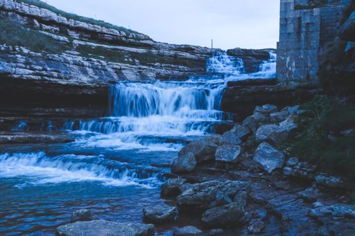 A beautiful view of a waterfall surrounded by mossy rocks - perfect for wallpaper