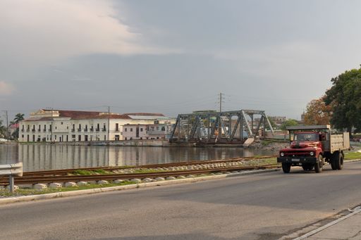 a view of the truck next to train tracks and lake