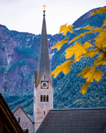 A vertical shot of the Hallstatt Evangelical Parish Church clock tower. Austria.