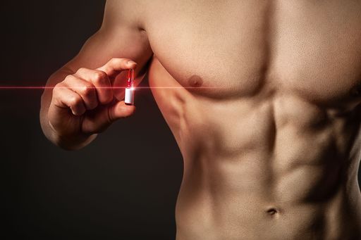 Liquid steroids hold in hands of a shirtless athletic man with muscles