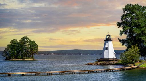 A beautiful view of a lighthouse at the shore at calm soft sunset - great for wallpaper