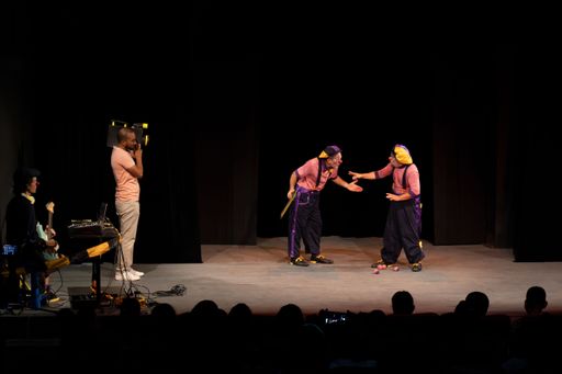 Funny clowns performing on the scene and a cameraman filming them, Matanzas, Cuba