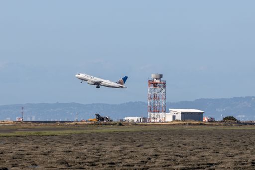 A United State airlines flight takes off over the airport in San Francisco