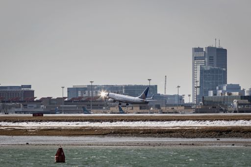 A scenic view of a a plane taking off from the airport in in Boston US
