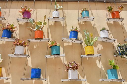 Pots of colorful flowers decorate a wall on a street in Galatina, a village in the province of Lecce