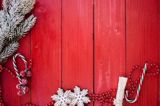 A red wooden planks backdrop with Christmas decorations and copy space