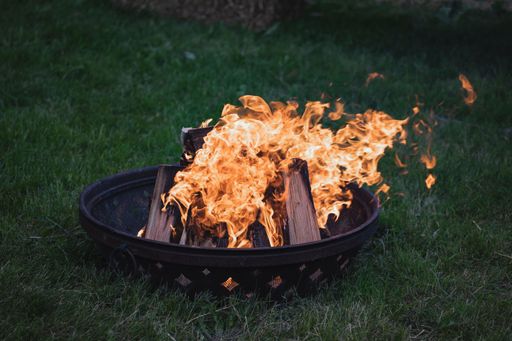A lit bonfire high detail flame wood recreation heat camping survival