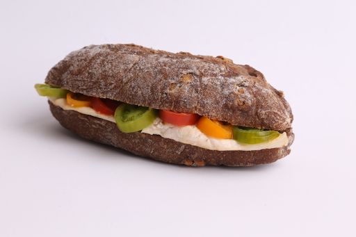 A high angle shot of a cheese sandwich with tomatoes isolated on a white surface