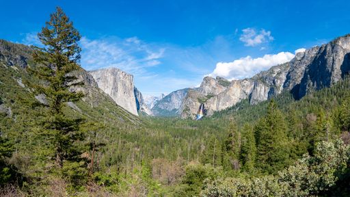 A view of Yosemite Valley from Tunnel View, in an afternoon with the rainbow in a waterfall