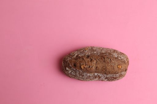 A high angle shot of homemade bread isolated on a pink surface