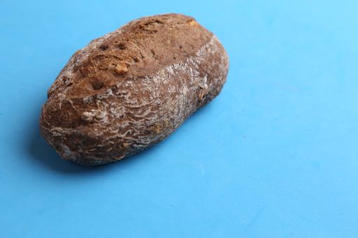 A high angle shot of homemade bread isolated on a blue surface