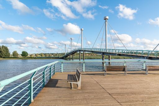 Two benches on a wooden pier over the river