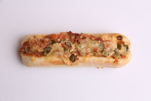 A high angle shot of a sandwich with grilled cheese with vegetables on a white surface