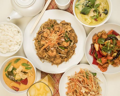 A high angle shot of some plates of different Chinese seafood