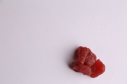 A top view of strawberry candies on a gray surface under the lights