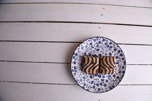 A top view of chocolate drizzled biscuits on a plate