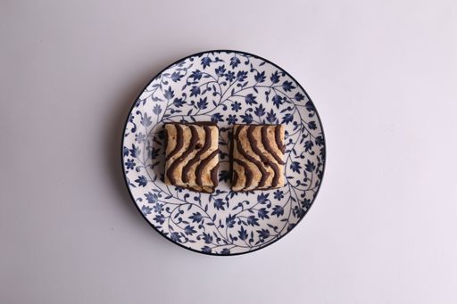 A high angle shot of a plate of homemade cookies isolated on a white surface