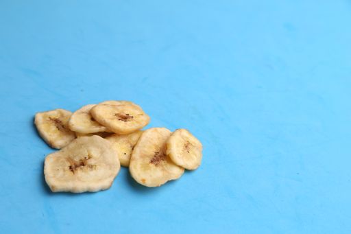 A closeup shot of small pieces of dried fruit on a monochrome background