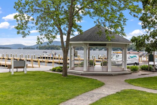 A beautiful shot of a pier and a small wedding ceremony area near the lake in New Hampshire