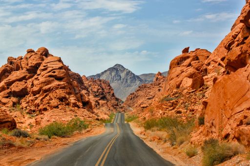 A road in between two rocks in the Valley of Fire, Nevada on a sunny day