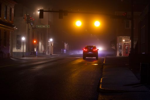 A night view of a street with cars and buildings in Virginia, United States