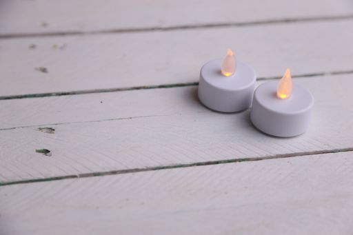 A high angle shot of toy candles on a wooden background