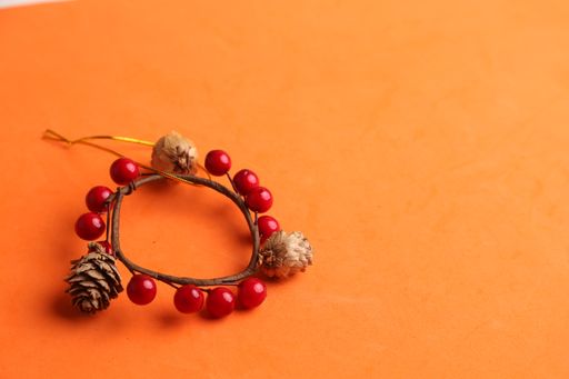 A closeup shot of a decorative wooden trinket isolated on an orange background