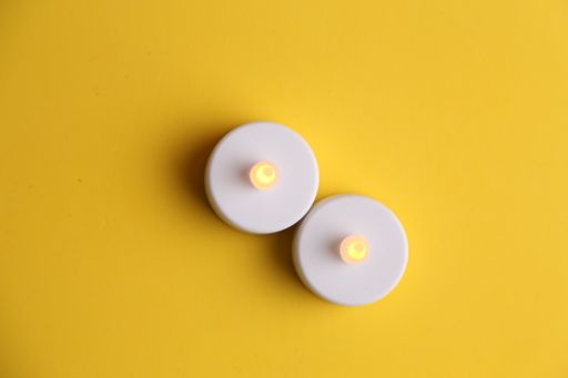 An overhead shot of toy candles isolated on a yellow background