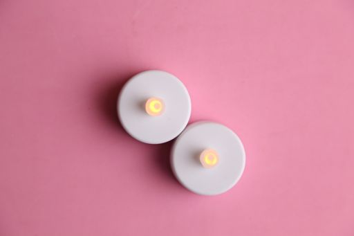 A top view of two plastic candles isolated on a pink surface