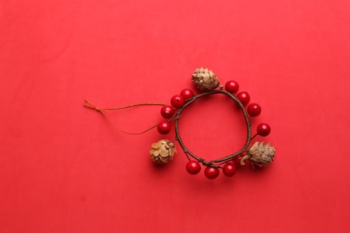 A closeup shot of a decorative wooden trinket isolated on a red background