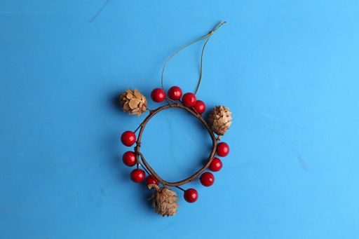 A high angle shot of a beautiful wooden trinket with red decorations