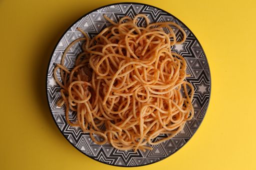 A top view of delicious fresh spaghetti in a bowl