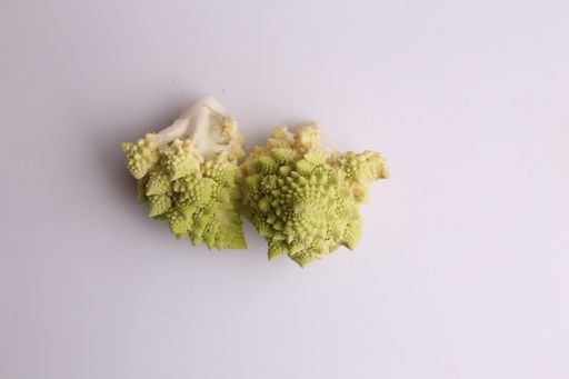 A high angle shot of some fresh broccoli isolated on a white surface