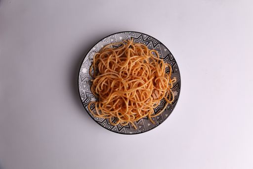 A plate of spaghetti pasta with tomato on color background